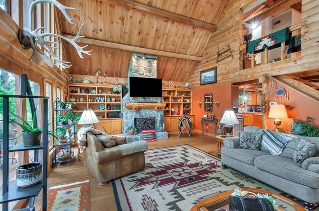 20151 Ben Fly Rd, Lyles, TN 37098 - living area featuring high vaulted ceiling, a wooden ceiling with exposed beams, wood finished floors, and a fireplace