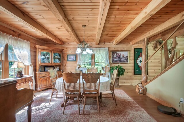 20151 Ben Fly Rd, Lyles, TN 37098 - dining area with a wooden ceiling with exposed beams, a chandelier, wood finished floors, stairway, and rustic walls