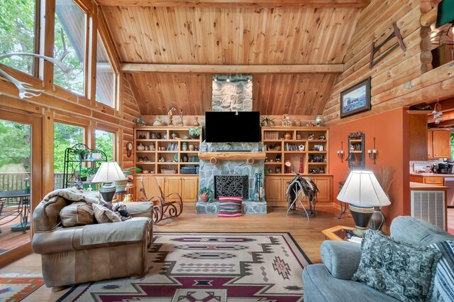 20151 Ben Fly Rd, Lyles, TN 37098 - living area featuring high vaulted ceiling, a wooden ceiling with exposed beams, rustic walls, wood finished floors, and a fireplace