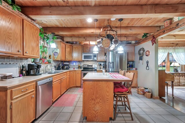 20151 Ben Fly Rd, Lyles, TN 37098 - kitchen with stainless steel appliances, light tile patterned floors, decorative backsplash, a wood ceiling with exposed beams, and light countertops