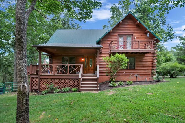 20151 Ben Fly Rd, Lyles, TN 37098 - log cabin featuring log siding, a front yard, a metal roof, and a balcony