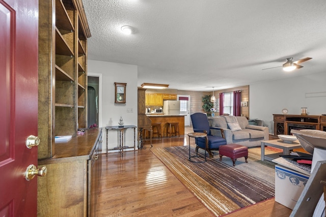 4628 Dugger Rd, Culleoka, TN 38451 - living room with a textured ceiling, light wood-style floors, and ceiling fan