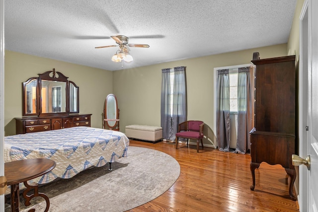 4628 Dugger Rd, Culleoka, TN 38451 - bedroom with wood finished floors, a textured ceiling, and a ceiling fan