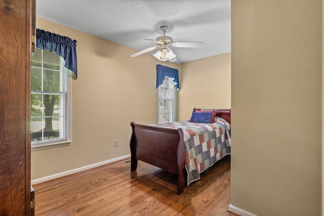 4628 Dugger Rd, Culleoka, TN 38451 - bedroom featuring wood finished floors, a textured ceiling, and a ceiling fan