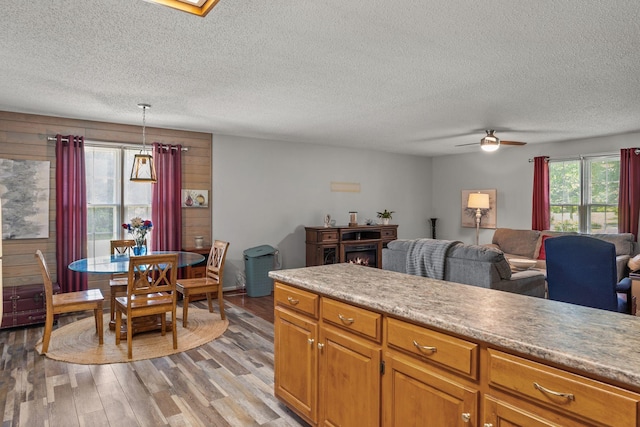4628 Dugger Rd, Culleoka, TN 38451 - kitchen featuring a ceiling fan, light wood-style flooring, a textured ceiling, light countertops, and decorative light fixtures