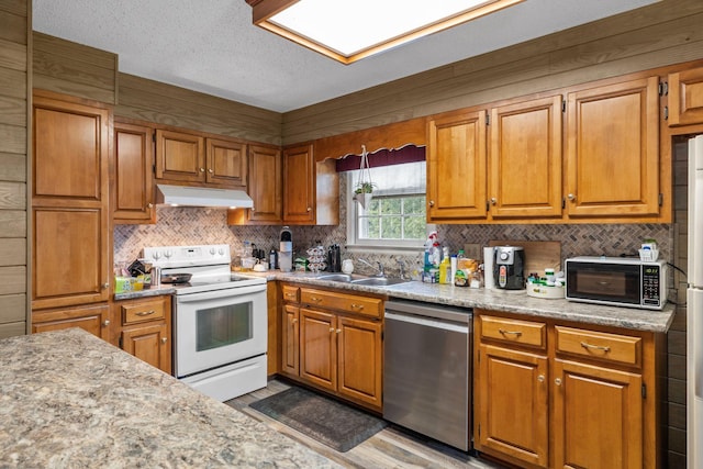 4628 Dugger Rd, Culleoka, TN 38451 - kitchen featuring stainless steel dishwasher, electric range, under cabinet range hood, tasteful backsplash, and light countertops