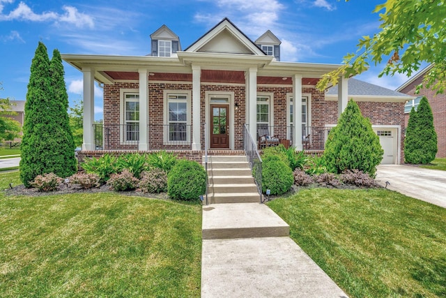 607 Beamon Dr, Franklin, TN 37064 - view of front of house featuring brick siding, covered porch, a front yard, and an attached garage
