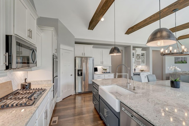 607 Beamon Dr, Franklin, TN 37064 - kitchen with appliances with stainless steel finishes, white cabinetry, dark wood-style floors, hanging light fixtures, and tasteful backsplash