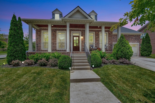 607 Beamon Dr, Franklin, TN 37064 - view of front of property featuring covered porch, brick siding, a lawn, and an attached garage