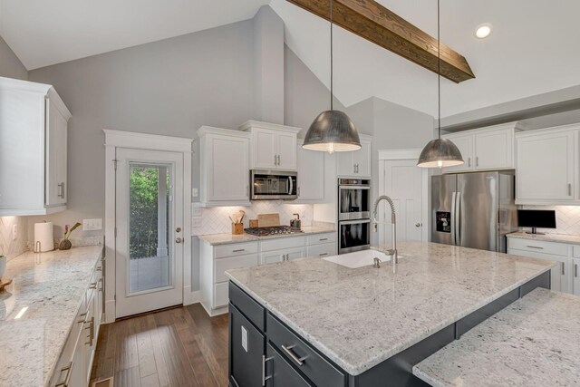 607 Beamon Dr, Franklin, TN 37064 - kitchen with appliances with stainless steel finishes, high vaulted ceiling, dark wood-type flooring, white cabinetry, and tasteful backsplash