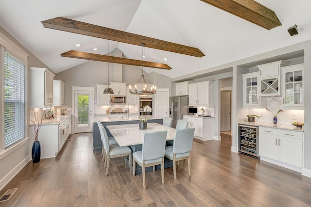 607 Beamon Dr, Franklin, TN 37064 - dining space with wine cooler, beam ceiling, a chandelier, dark wood-type flooring, and recessed lighting