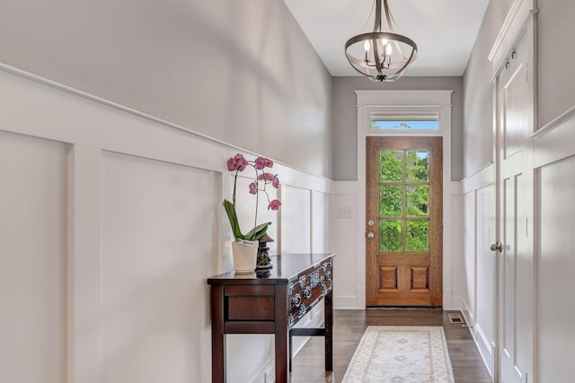 607 Beamon Dr, Franklin, TN 37064 - foyer featuring a chandelier, dark wood-type flooring, a decorative wall, and wainscoting