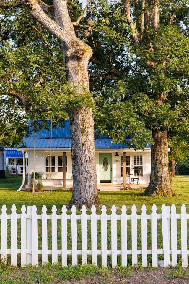 7365 Coldwater Rd, Fairview, TN 37062 - view of front of home featuring a porch, a fenced front yard, and a metal roof