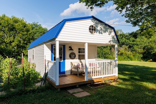 7365 Coldwater Rd, Fairview, TN 37062 - view of front of property with a gambrel roof, a metal roof, a front lawn, and an outdoor structure