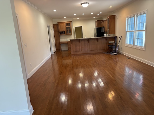 111 Reeds Ln, Sewanee, TN 37375 - kitchen featuring fridge, brown cabinets, a peninsula, dark wood finished floors, and a kitchen bar