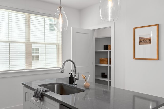 700 N Dupont Ave Unit 207, Madison, TN 37115 - kitchen with dark stone countertops, pendant lighting, and white cabinetry