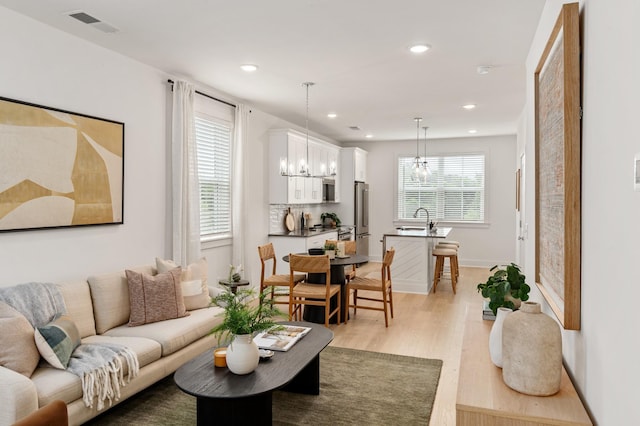 700 N Dupont Ave Unit 207, Madison, TN 37115 - living room featuring a chandelier, light wood-style floors, and recessed lighting