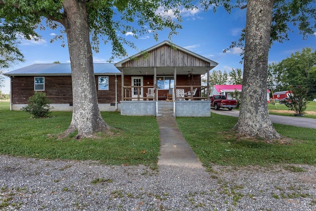 111 School St, Cumberland Furnace, TN 37051 - view of front of house with covered porch, a front lawn, and a metal roof