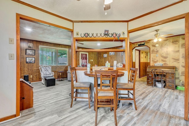 111 School St, Cumberland Furnace, TN 37051 - dining area featuring ceiling fan, wood finished floors, a textured ceiling, wooden walls, and ornamental molding