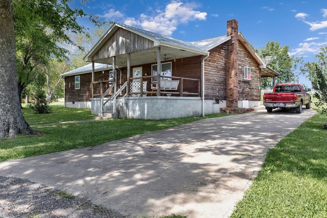111 School St, Cumberland Furnace, TN 37051 - view of front of property with covered porch, a chimney, concrete driveway, a front lawn, and crawl space