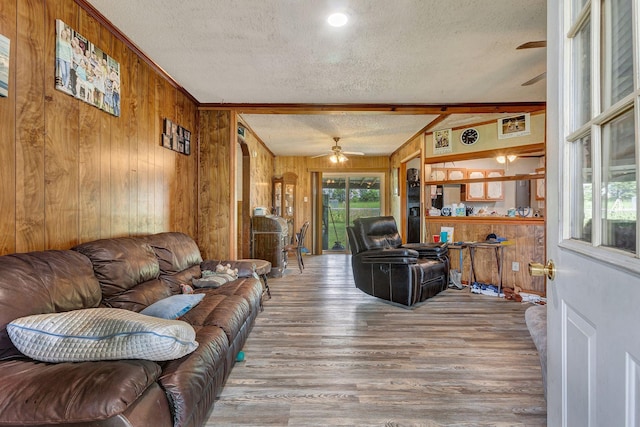 111 School St, Cumberland Furnace, TN 37051 - living room featuring a ceiling fan, a textured ceiling, wooden walls, and wood finished floors