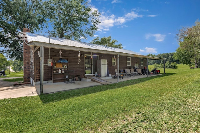 111 School St, Cumberland Furnace, TN 37051 - rear view of property featuring a chimney, a yard, a patio area, and a metal roof