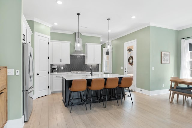 2618 Buckner Ln, Thompsons Station, TN 37179 - kitchen with wall chimney exhaust hood, freestanding refrigerator, backsplash, a breakfast bar, and ornamental molding