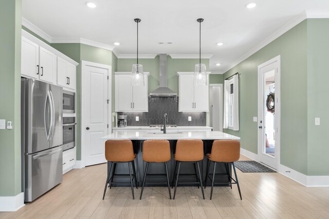2618 Buckner Ln, Thompsons Station, TN 37179 - kitchen featuring stainless steel appliances, wall chimney range hood, light countertops, white cabinetry, and backsplash