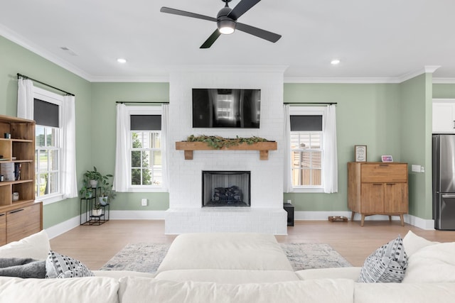 2618 Buckner Ln, Thompsons Station, TN 37179 - living room featuring crown molding, wood finished floors, ceiling fan, a fireplace, and recessed lighting
