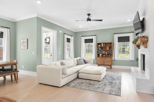 2618 Buckner Ln, Thompsons Station, TN 37179 - living area with a fireplace, a ceiling fan, light wood-style flooring, healthy amount of natural light, and ornamental molding
