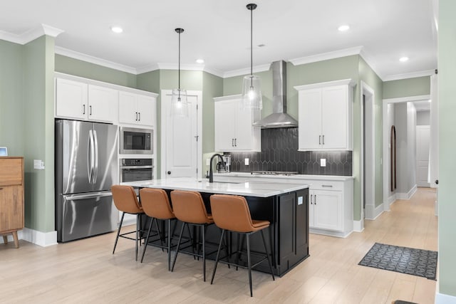 2618 Buckner Ln, Thompsons Station, TN 37179 - kitchen featuring stainless steel appliances, wall chimney range hood, decorative backsplash, a kitchen bar, and white cabinetry