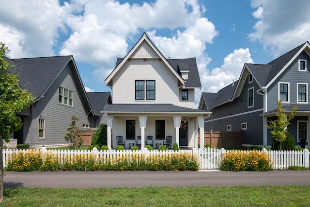 2618 Buckner Ln, Thompsons Station, TN 37179 - view of front facade with a porch, a fenced front yard, and board and batten siding