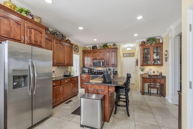 973 Rip Steele Rd, Columbia, TN 38401 - kitchen with stainless steel appliances, ornamental molding, tasteful backsplash, a kitchen breakfast bar, and light tile patterned flooring
