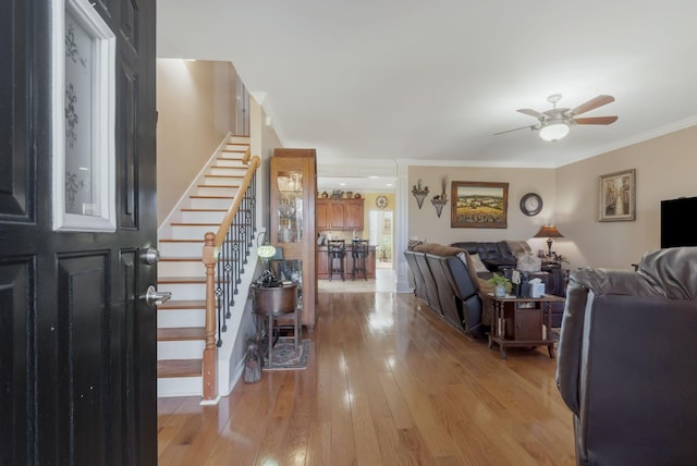 973 Rip Steele Rd, Columbia, TN 38401 - living room with a ceiling fan, stairs, light wood-type flooring, and crown molding