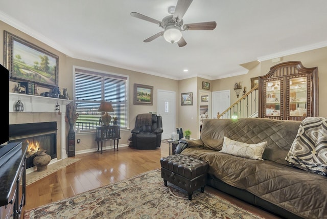 973 Rip Steele Rd, Columbia, TN 38401 - living area with ceiling fan, hardwood / wood-style flooring, a tile fireplace, ornamental molding, and stairway