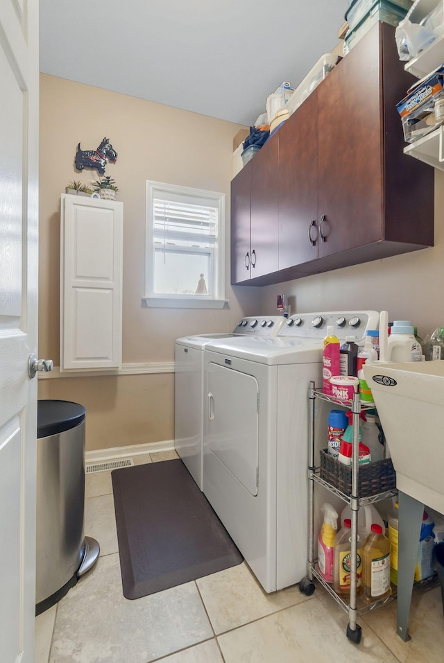 973 Rip Steele Rd, Columbia, TN 38401 - washroom featuring cabinet space, separate washer and dryer, and light tile patterned flooring