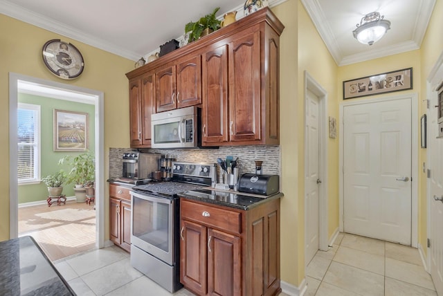 973 Rip Steele Rd, Columbia, TN 38401 - kitchen with appliances with stainless steel finishes, ornamental molding, light tile patterned floors, tasteful backsplash, and dark stone counters