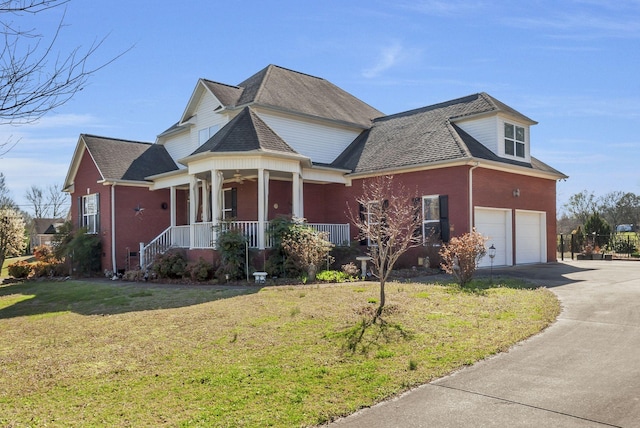 973 Rip Steele Rd, Columbia, TN 38401 - view of front of home with covered porch, driveway, a front yard, an attached garage, and roof with shingles