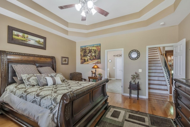 973 Rip Steele Rd, Columbia, TN 38401 - bedroom featuring wood finished floors, a tray ceiling, and a ceiling fan