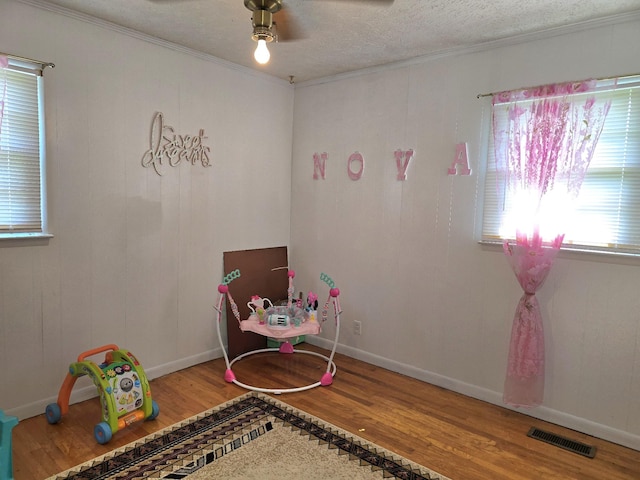 5840 Scottsville Rd, Lafayette, TN 37083 - game room with wood finished floors, ornamental molding, a ceiling fan, and a textured ceiling