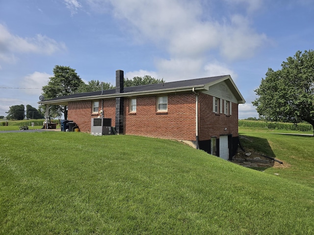 5840 Scottsville Rd, Lafayette, TN 37083 - rear view of property with an attached garage, a yard, and brick siding