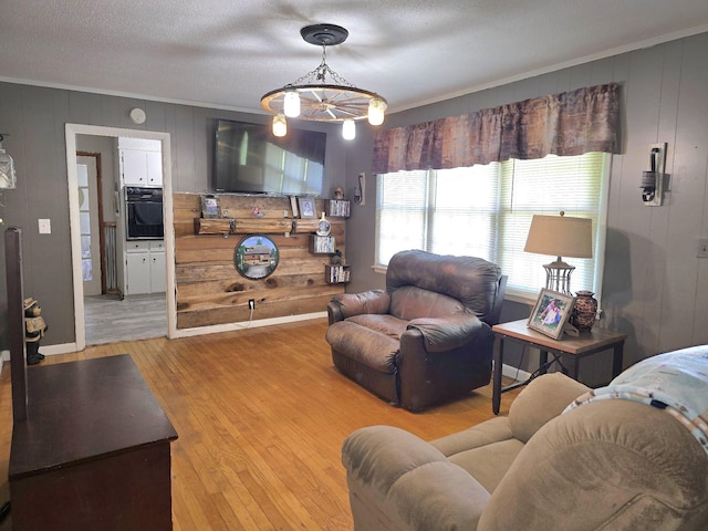5840 Scottsville Rd, Lafayette, TN 37083 - living room with ornamental molding, light wood finished floors, wood walls, and a chandelier