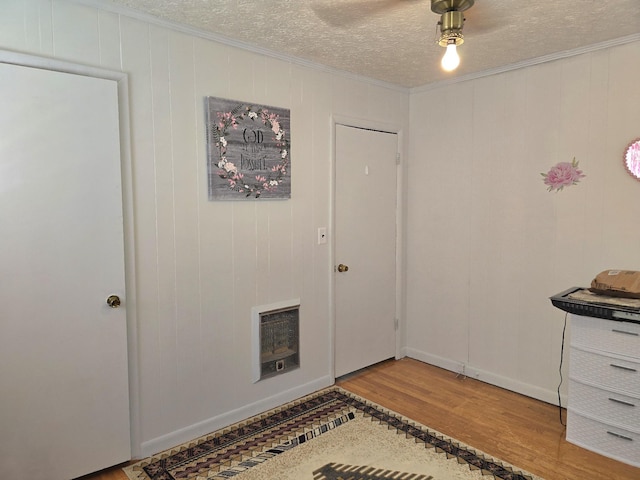 5840 Scottsville Rd, Lafayette, TN 37083 - entrance foyer with wood finished floors, heating unit, crown molding, and a textured ceiling