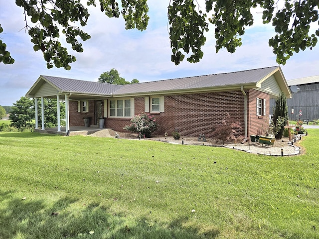 5840 Scottsville Rd, Lafayette, TN 37083 - view of front of home with brick siding, a front lawn, and a metal roof