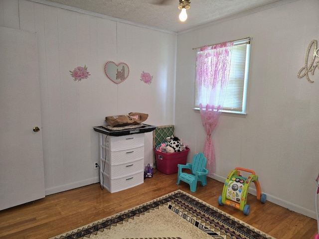 5840 Scottsville Rd, Lafayette, TN 37083 - game room featuring wood finished floors, crown molding, and a textured ceiling