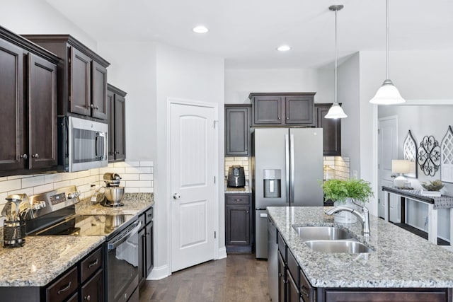 2426 Telford Ln, Murfreesboro, TN 37128 - kitchen with stainless steel appliances, a center island with sink, dark brown cabinets, dark wood-style flooring, and recessed lighting