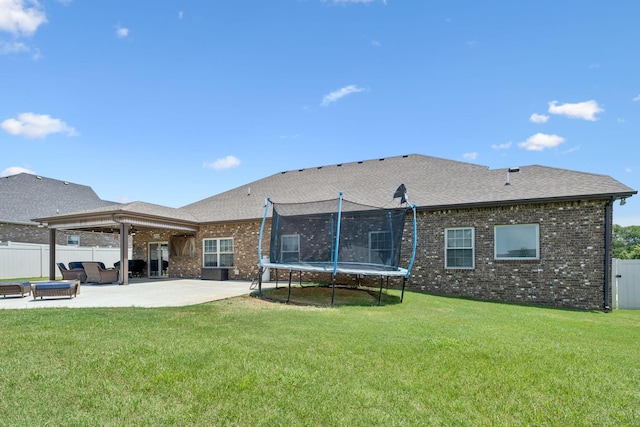 2426 Telford Ln, Murfreesboro, TN 37128 - back of property with a trampoline, a patio, brick siding, and roof with shingles