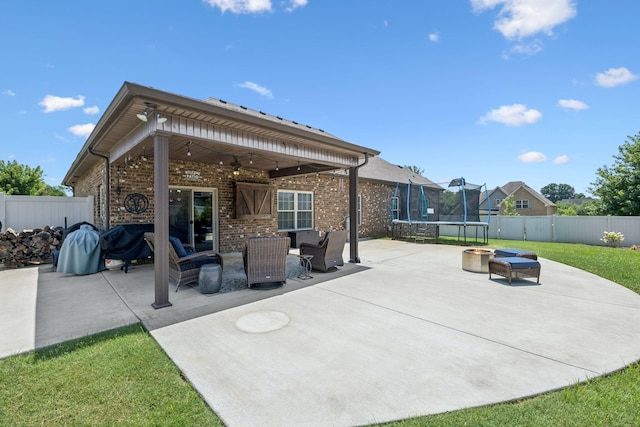 2426 Telford Ln, Murfreesboro, TN 37128 - fenced backyard featuring a trampoline, a ceiling fan, a patio, and an outdoor hangout area