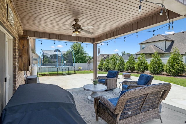 2426 Telford Ln, Murfreesboro, TN 37128 - fenced backyard featuring a trampoline, a patio, ceiling fan, and an outdoor living space
