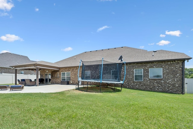 2426 Telford Ln, Murfreesboro, TN 37128 - rear view of house with a trampoline, a patio area, brick siding, a fenced backyard, and roof with shingles